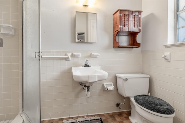 303 Luby Dr, Tom Bean, TX 75489 - bathroom with a stall shower, toilet, tile walls, and a wainscoted wall