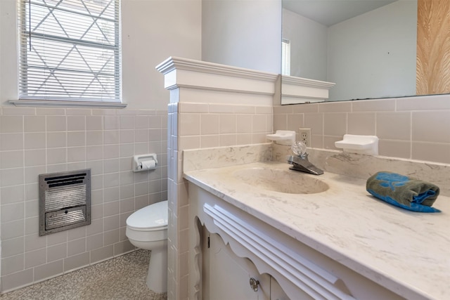 303 Luby Dr, Tom Bean, TX 75489 - half bath featuring tile walls, heating unit, toilet, vanity, and wainscoting