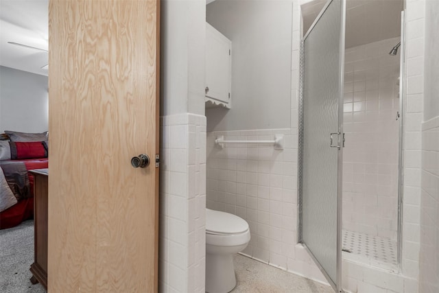 303 Luby Dr, Tom Bean, TX 75489 - full bath featuring a shower stall, ensuite bathroom, tile walls, a wainscoted wall, and toilet