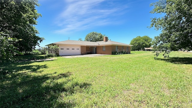 303 Luby Dr, Tom Bean, TX 75489 - view of grassy yard featuring a garage and driveway