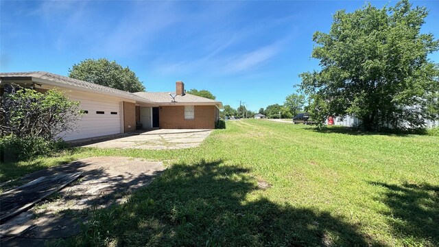 303 Luby Dr, Tom Bean, TX 75489 - view of green lawn with a garage and driveway