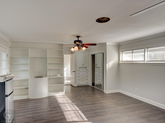 unfurnished living room with crown molding, ceiling fan, dark wood-style flooring, and baseboards