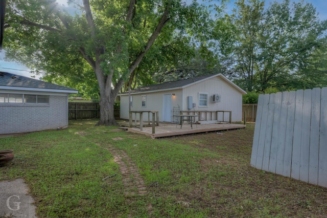 back of property with a wooden deck and brick siding