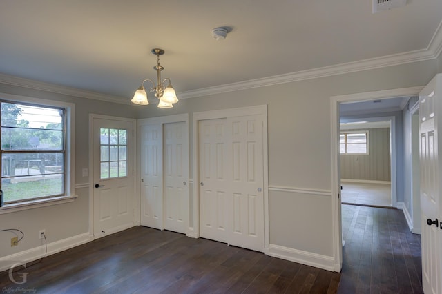 unfurnished dining area with a chandelier, baseboards, dark wood finished floors, and crown molding