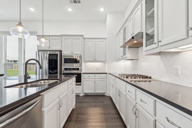 1654 Castleford Dr, Forney, TX 75126 - kitchen with appliances with stainless steel finishes, a sink, dark countertops, backsplash, and pendant lighting