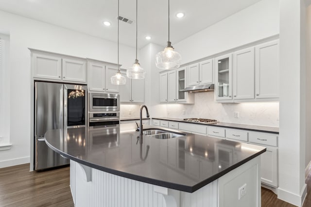 1654 Castleford Dr, Forney, TX 75126 - kitchen with stainless steel appliances, a sink, dark countertops, dark wood-style flooring, and backsplash