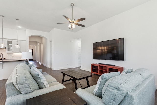 1654 Castleford Dr, Forney, TX 75126 - living area with arched walkways, a ceiling fan, dark wood-style floors, baseboards, and recessed lighting