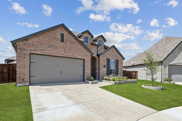 1654 Castleford Dr, Forney, TX 75126 - french country style house featuring brick siding, concrete driveway, and an attached garage