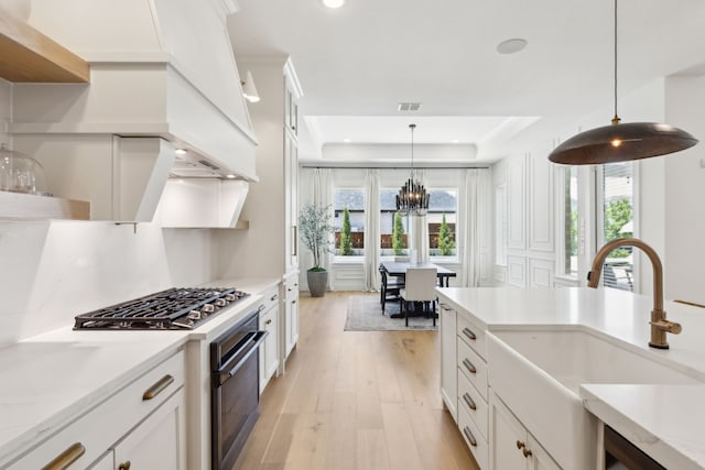 1421 Maplewood Dr, Prosper, TX 75078 - kitchen featuring range with gas cooktop, light wood-type flooring, white cabinets, a chandelier, and recessed lighting