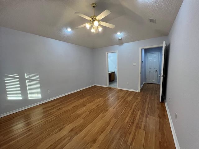 920 Joshua Dr, Burleson, TX 76028 - spare room with wood finished floors, ceiling fan, lofted ceiling, baseboards, and a textured ceiling