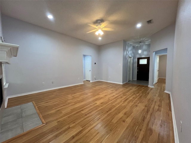 920 Joshua Dr, Burleson, TX 76028 - unfurnished living room with a ceiling fan, light wood finished floors, a fireplace, baseboards, and recessed lighting