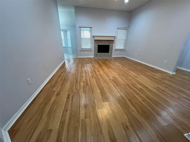920 Joshua Dr, Burleson, TX 76028 - unfurnished living room with wood finished floors, baseboards, and a fireplace