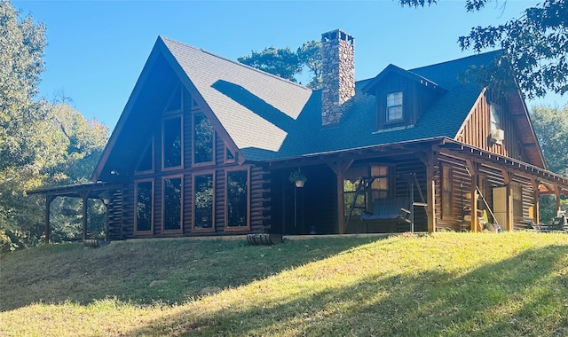 637 County Road 4420, Winnsboro, TX 75494 - back of property with a chimney, a lawn, and log siding