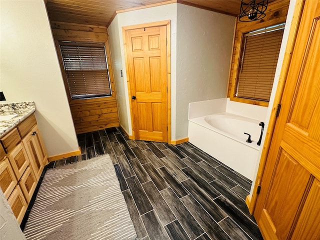 637 County Road 4420, Winnsboro, TX 75494 - bathroom with wood finish floors, baseboards, a bath, vanity, and wooden ceiling