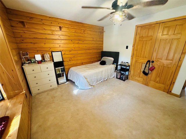 637 County Road 4420, Winnsboro, TX 75494 - bedroom featuring carpet flooring, wood walls, a ceiling fan, and a closet