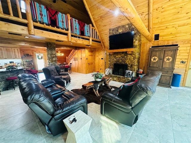 637 County Road 4420, Winnsboro, TX 75494 - living room featuring wooden walls, high vaulted ceiling, decorative columns, wooden ceiling, and a stone fireplace