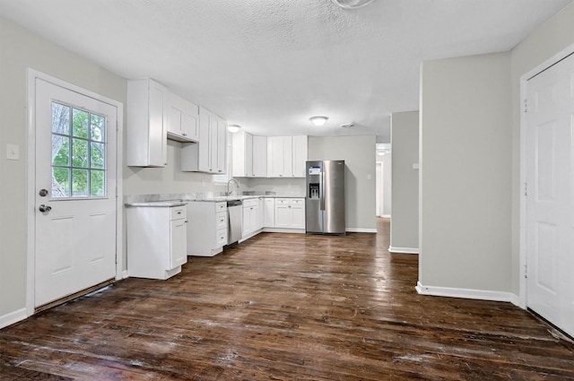 2519 N Hickory St, Sherman, TX 75092 - kitchen featuring stainless steel appliances, dark wood finished floors, a sink, light countertops, and baseboards