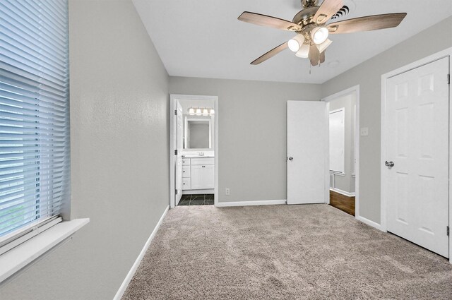 2519 N Hickory St, Sherman, TX 75092 - unfurnished bedroom featuring carpet flooring, baseboards, connected bathroom, and a ceiling fan