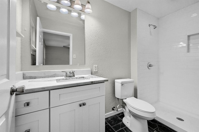 2519 N Hickory St, Sherman, TX 75092 - bathroom with toilet, marble look tiles, a textured wall, baseboards, and vanity