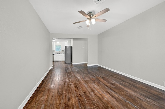 2519 N Hickory St, Sherman, TX 75092 - unfurnished living room featuring a ceiling fan, dark wood finished floors, baseboards, and a sink