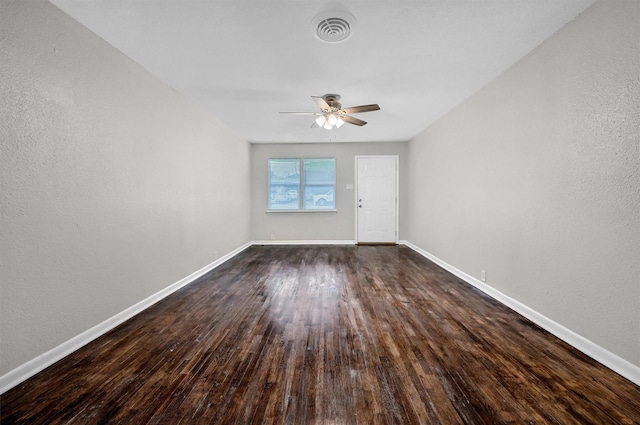 2519 N Hickory St, Sherman, TX 75092 - unfurnished room featuring a ceiling fan, baseboards, dark wood-style flooring, and a textured wall