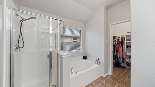 2005 Sterling Gate Dr, Heartland, TX 75126 - bathroom with a stall shower, a bath, tile patterned floors, a walk in closet, and vaulted ceiling