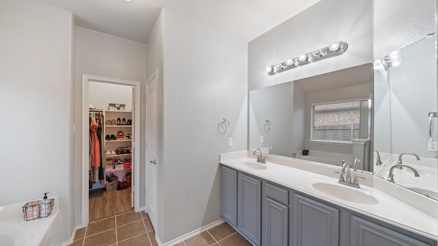 2005 Sterling Gate Dr, Heartland, TX 75126 - full bathroom with tile patterned flooring, a bath, double vanity, a spacious closet, and baseboards