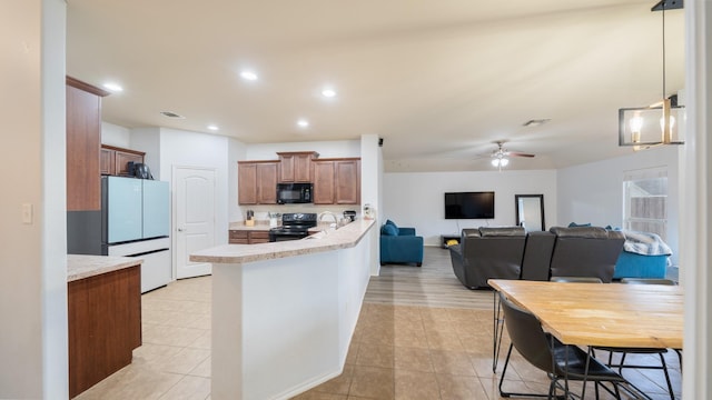 2005 Sterling Gate Dr, Heartland, TX 75126 - kitchen featuring black appliances, light countertops, ceiling fan, light tile patterned flooring, and a peninsula