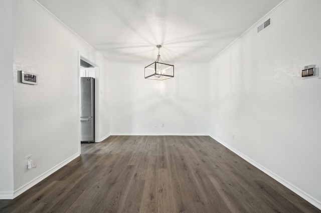 8609 N Normandale St, Fort Worth, TX 76116 - unfurnished dining area featuring ornamental molding, dark wood finished floors, and a chandelier