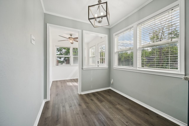 8609 N Normandale St, Fort Worth, TX 76116 - unfurnished dining area with healthy amount of natural light, dark wood-style floors, ornamental molding, a chandelier, and a ceiling fan
