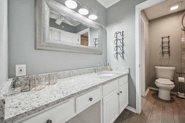 8609 N Normandale St, Fort Worth, TX 76116 - bathroom featuring double vanity, a ceiling fan, and wood finished floors