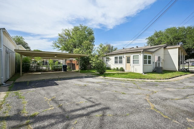 8609 N Normandale St, Fort Worth, TX 76116 - back of house featuring asphalt driveway and a detached carport