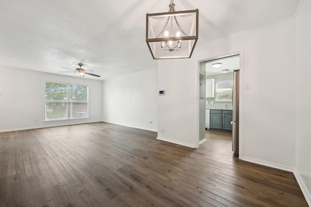 8609 N Normandale St, Fort Worth, TX 76116 - unfurnished living room featuring a chandelier, dark wood finished floors, and ceiling fan