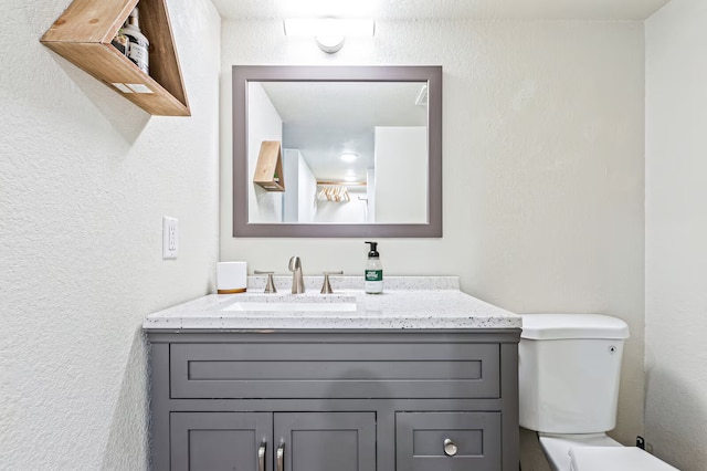 724 N Old Robinson Rd, Robinson, TX 76706 - bathroom featuring toilet, vanity, and a textured wall