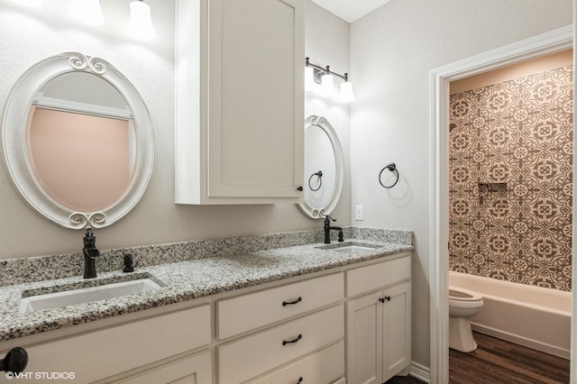 344 Whispering Oaks Trl, Sunset, TX 76270 - bathroom with toilet, wood finished floors, double vanity, and washtub / shower combination