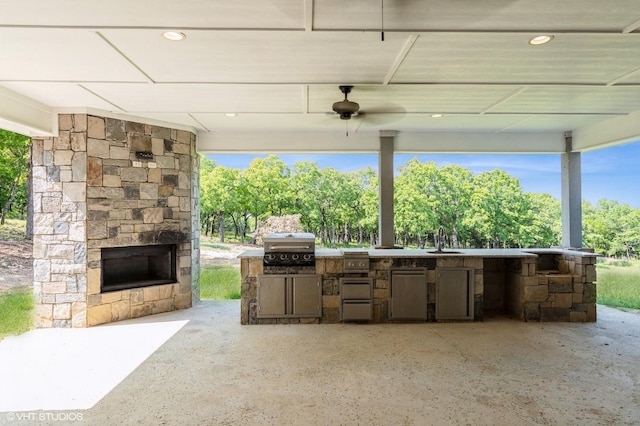 344 Whispering Oaks Trl, Sunset, TX 76270 - view of patio featuring exterior kitchen, an outdoor stone fireplace, grilling area, and a sink