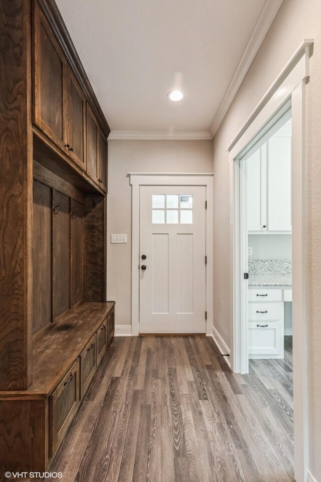 344 Whispering Oaks Trl, Sunset, TX 76270 - mudroom featuring dark wood-type flooring, crown molding, and baseboards