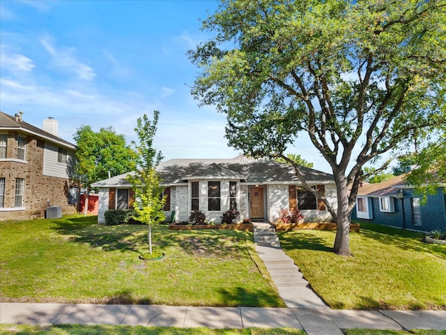 3507 Jasmine Ln, Rowlett, TX 75089 - view of front of house with a front lawn, central AC unit, and brick siding