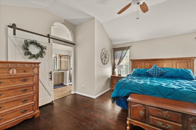 3507 Jasmine Ln, Rowlett, TX 75089 - bedroom with lofted ceiling, a barn door, dark wood finished floors, baseboards, and ensuite bath