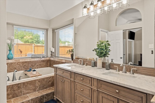 3507 Jasmine Ln, Rowlett, TX 75089 - bathroom with vaulted ceiling, healthy amount of natural light, a bath, and double vanity