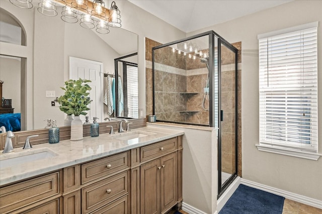 3507 Jasmine Ln, Rowlett, TX 75089 - bathroom with a shower stall, double vanity, connected bathroom, and a chandelier