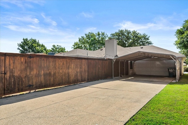 3507 Jasmine Ln, Rowlett, TX 75089 - view of property exterior featuring driveway, fence, a chimney, a carport, and an attached garage