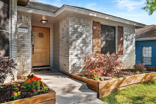 3507 Jasmine Ln, Rowlett, TX 75089 - doorway to property with a shingled roof and brick siding