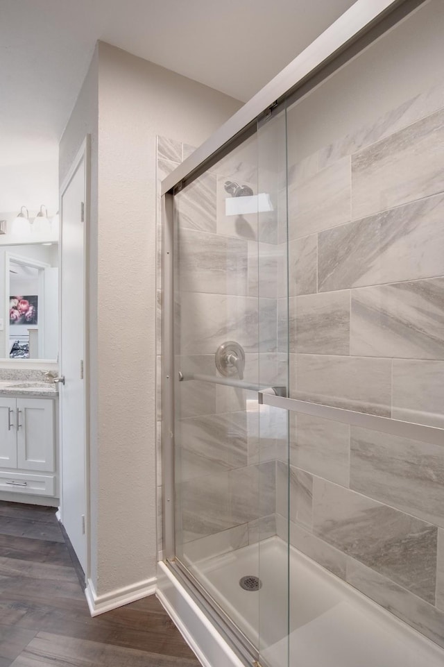 626 Lochngreen Trl, Arlington, TX 76012 - full bath featuring a shower stall, vanity, wood finished floors, and baseboards