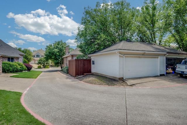 626 Lochngreen Trl, Arlington, TX 76012 - view of home's exterior featuring fence, an attached garage, concrete driveway, and an outdoor structure