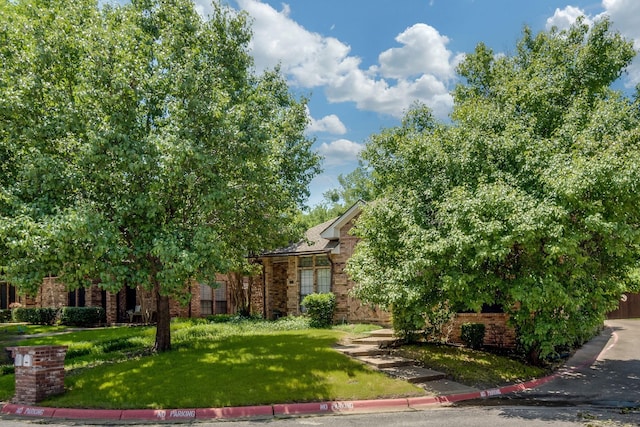 626 Lochngreen Trl, Arlington, TX 76012 - obstructed view of property with brick siding and a front yard