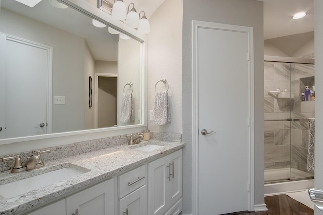 626 Lochngreen Trl, Arlington, TX 76012 - full bath featuring a shower with shower door, double vanity, and wood finished floors