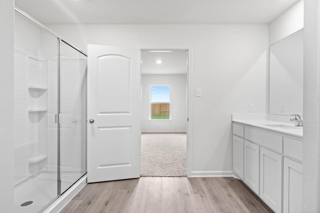 4809 Fillmore Dr, Greenville, TX 75401 - bathroom with wood finished floors, a stall shower, vanity, and baseboards