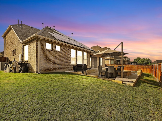 2812 Castlereach St, Trophy Club, TX 76262 - rear view of house with a patio area, solar panels, brick siding, and a shingled roof