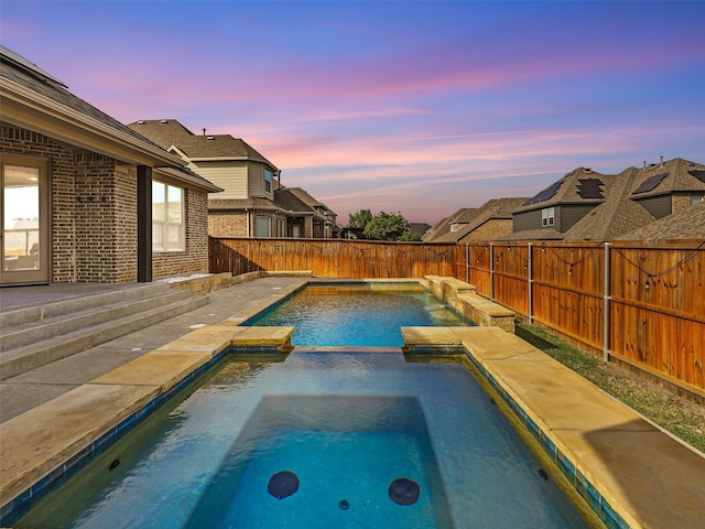 2812 Castlereach St, Trophy Club, TX 76262 - pool at dusk featuring a fenced backyard and a pool with connected hot tub